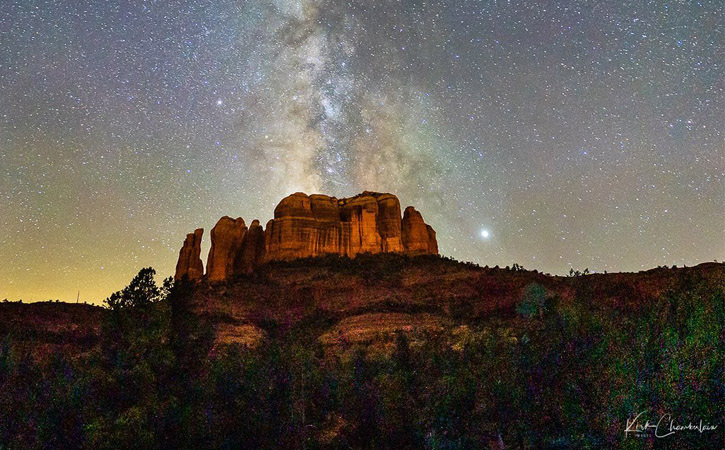 The Milky Way can be seen above a large mountain (Cathedral Rock) in Sedona