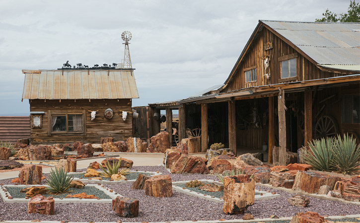 Old West buildings encircle a small garden of petroglyphs on display