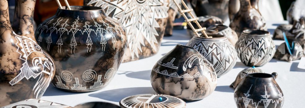 Pottery for sale lines a table at the American Indian Festival in Scottsdale