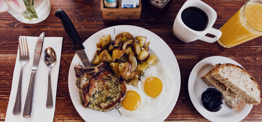 A typical meal of potatoes, eggs, coffee and a pork chop at Matt