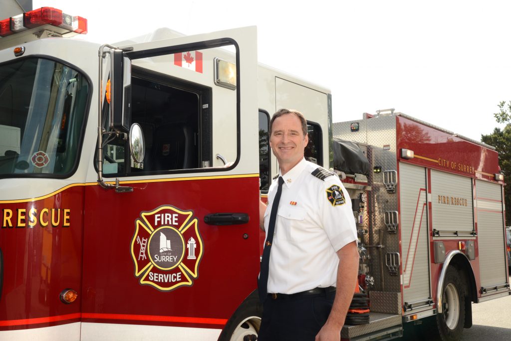 Assistant Chief, Steve Robinson stands by an Engine at Firehall. Photo: Ray Hudson