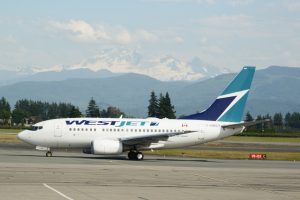 One of seven WestJet daily flights taxis to the terminal with Mount Baker in the background. Photo: Ray Hudson