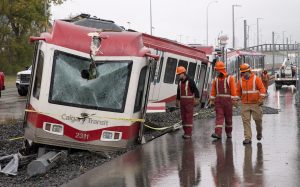 Crews attend the scene of an LRT accident and derailment in northwest Calgary, Alberta on Tuesday, Sept. 20, 2016. The driver of a Calgary Transit train has been seriously injured in a derailment that happened during the morning rush. The C-train derailed at the Tuscany station at about 7 a.m. THE CANADIAN PRESS/Larry MacDougal