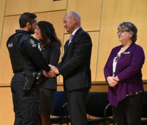 Cst. Sarb Singh shaking hands with Alexa Middelaer’s father, Michael.