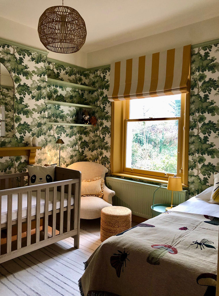 A nursery with botanical wallpaper