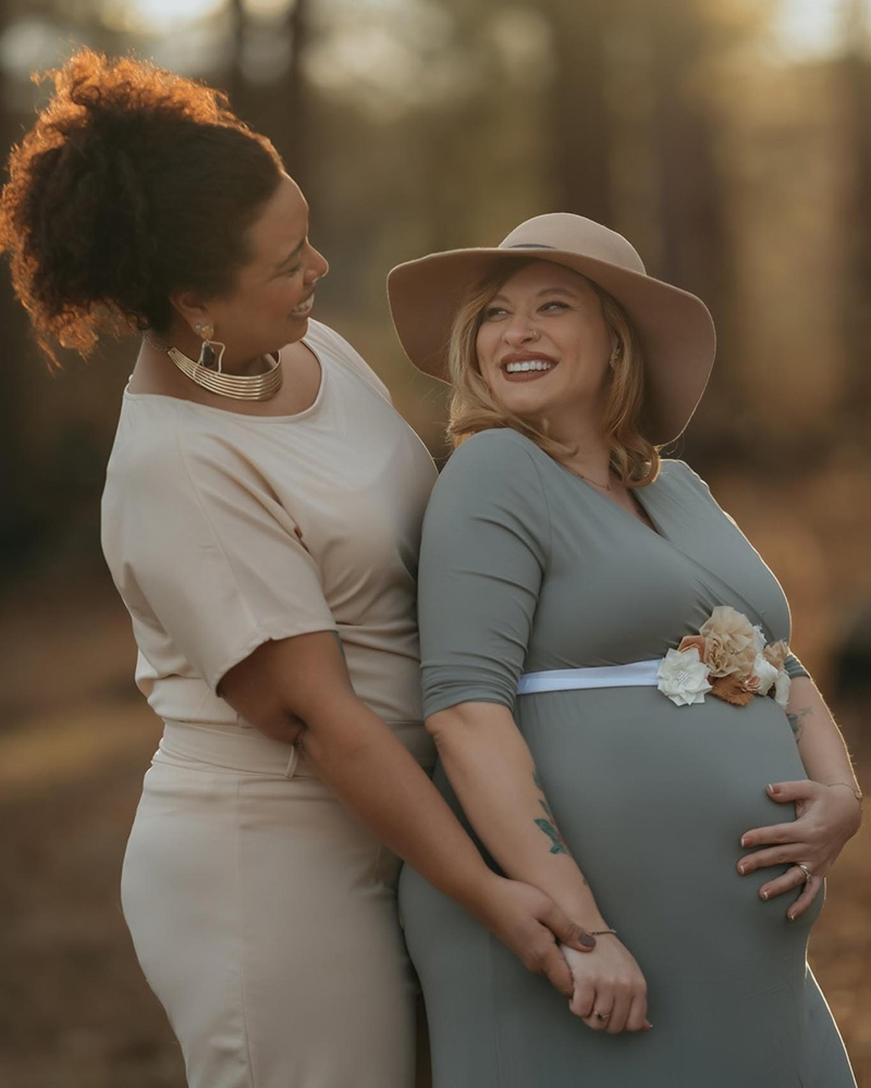 Jordana hugging her pregnant wife Melanie