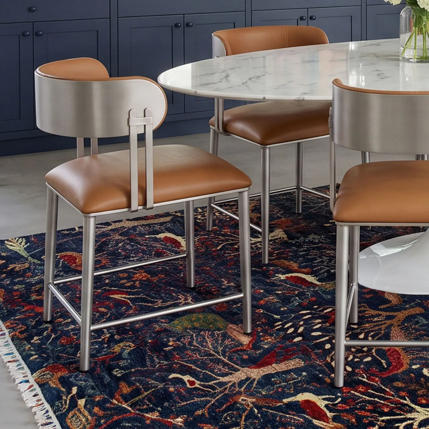 Closeup of three Sinclair dining chairs (DC807H18) in Hand Brushed Champagne and Dillon Luggage vinyl around a modern white table in an eclectic dining room.