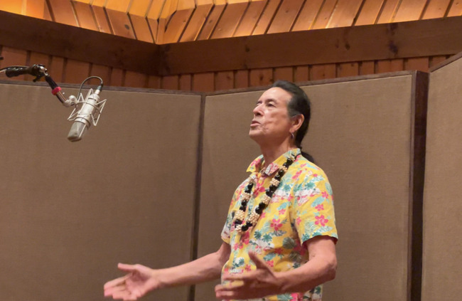 Tchin performing in a recording studio