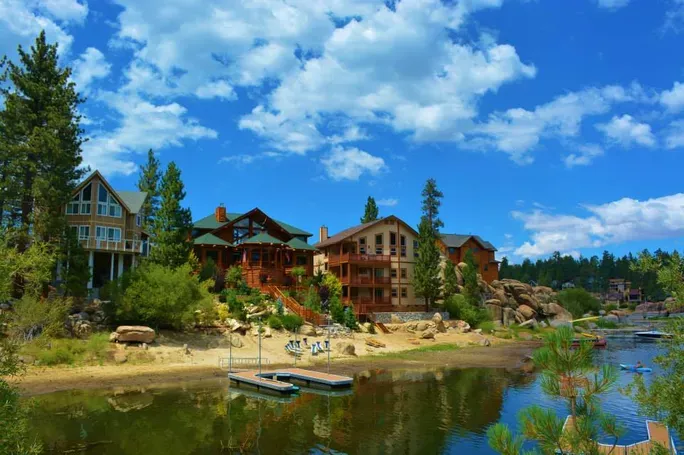 Lakeside cabins and vacation homes in Big Bear Lake California under a bright blue sky