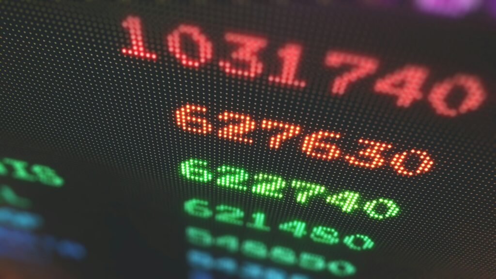 A digital display shows large red and green numbers, resembling a stock market or financial data screen—perfect for tracking RSUs or stock options in California divorce settlements.