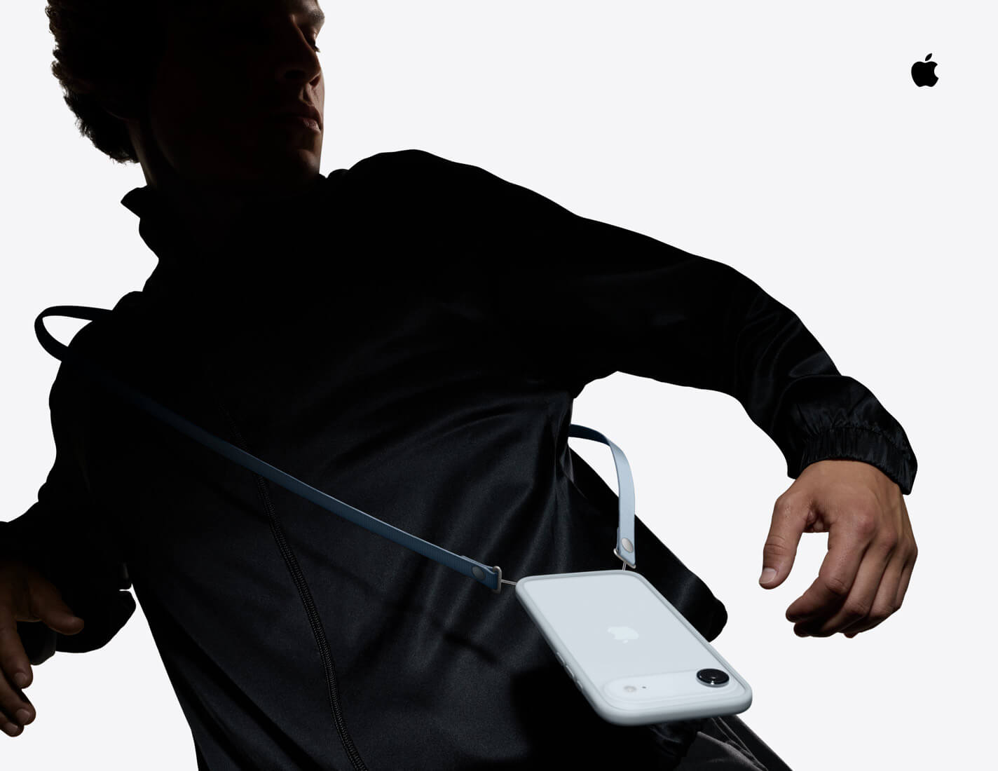 Person wearing iPhone Air, Sky Blue color, with iPhone Air Bumper attached, and blue Crossbody Strap attached, worn around their shoulder