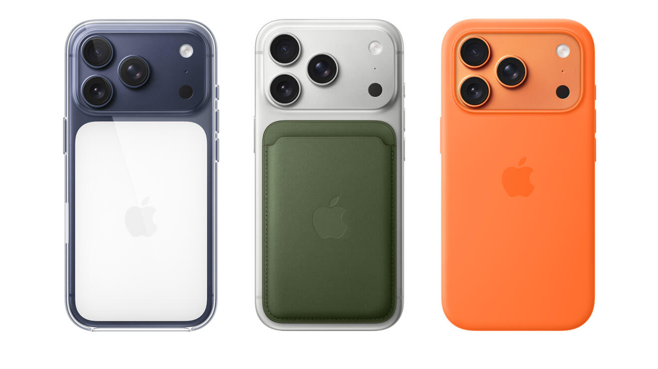 Side-by-side, 3 iPhone 17 models, back exterior view, left to right, in Deep Blue finish inside Clear Case, in Silver finish with green MagSafe wallet attached, in Cosmic Orange finish, inside Orange Silicone Case