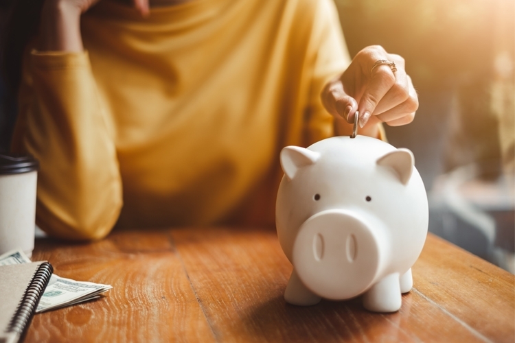 Woman adding money to her piggy bank mtime20190401124330focalnone