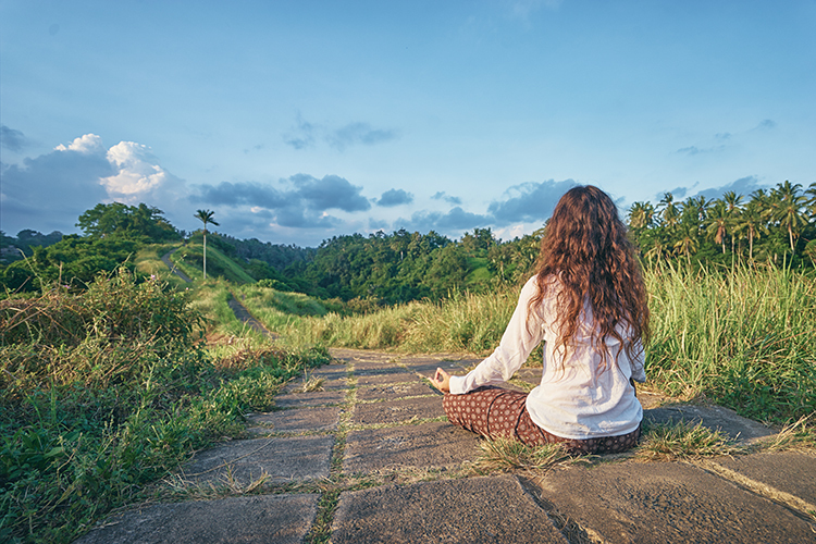 Woman meditating outside on a path mtime20170317000029focalnone