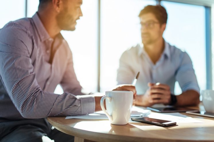 Two Male Coworkers Talking