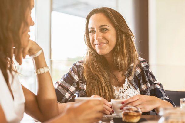 Woman Drinking Coffee And Smiling