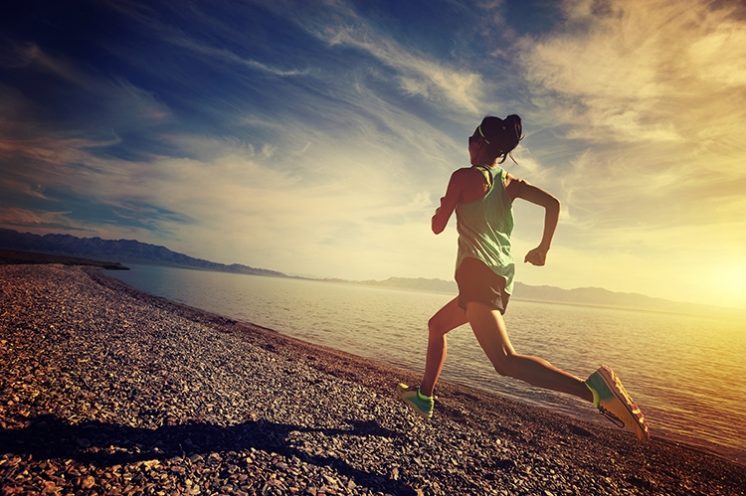 Woman Running Along Beach