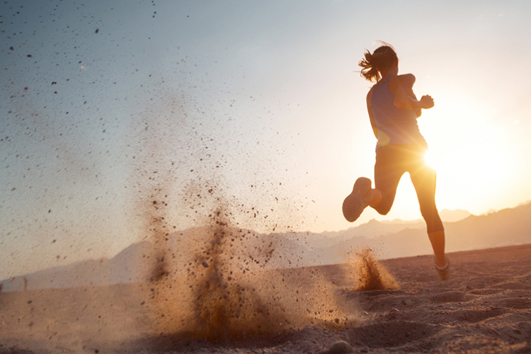 Woman Running In The Sand