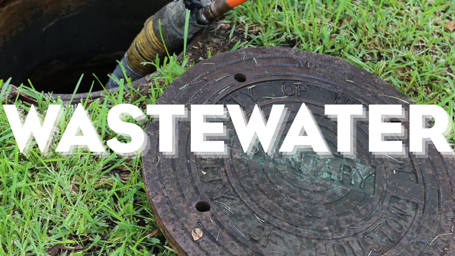 Wastewater maintenance image showing an open manhole and equipment near a City of Houston sewer cover.
