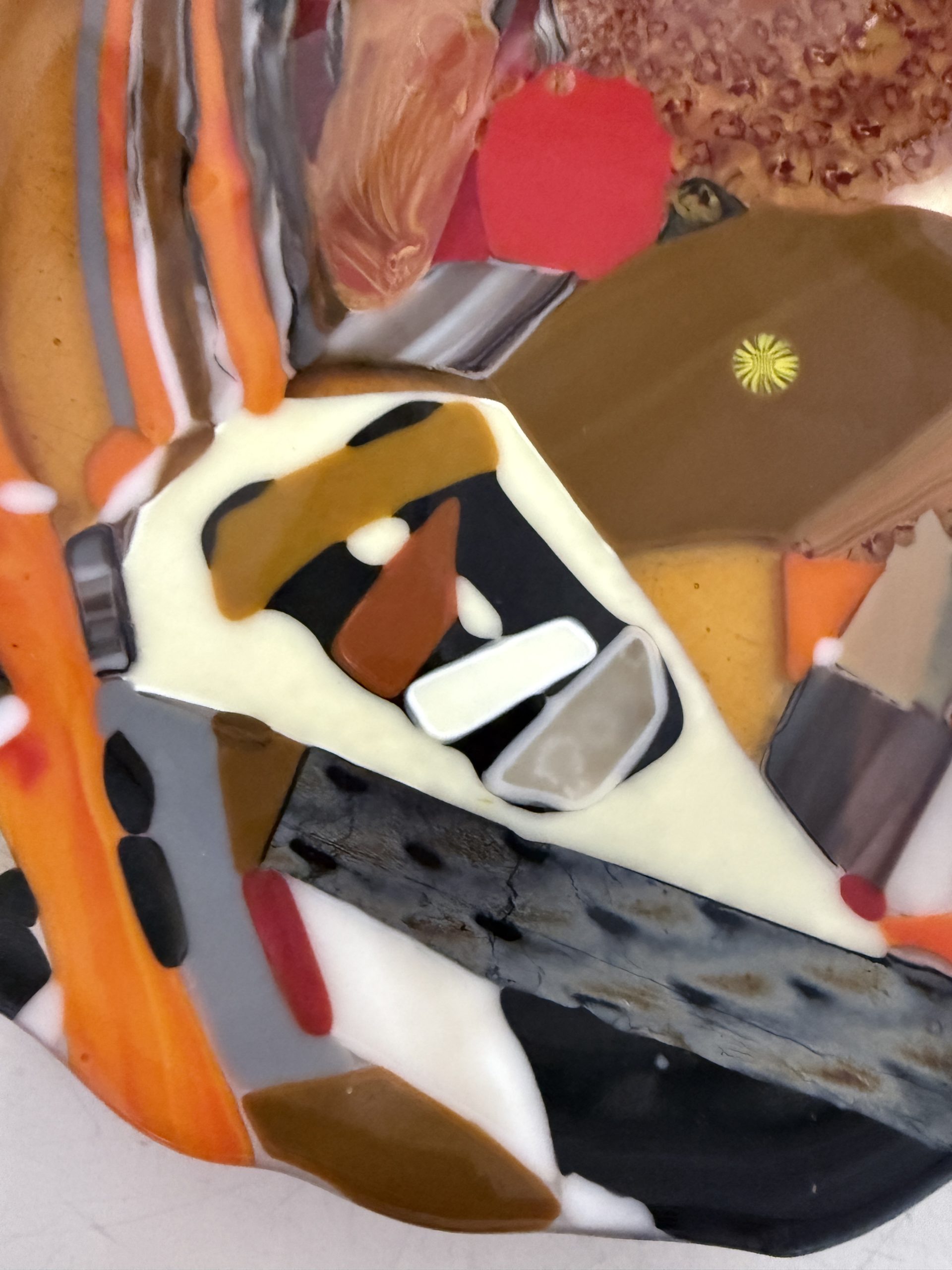 Fused glass plate featuring rich autumn tones of amber, orange, brown, cream, and black with intricate layered patterns that capture the warmth and movement of fall.