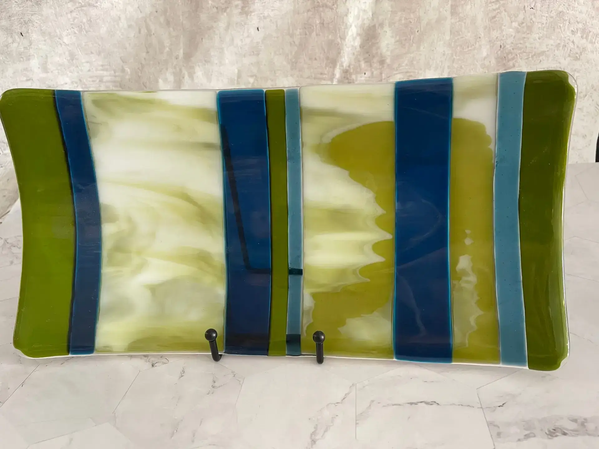 Detail view of green navy and ivory bands in Olive Grove