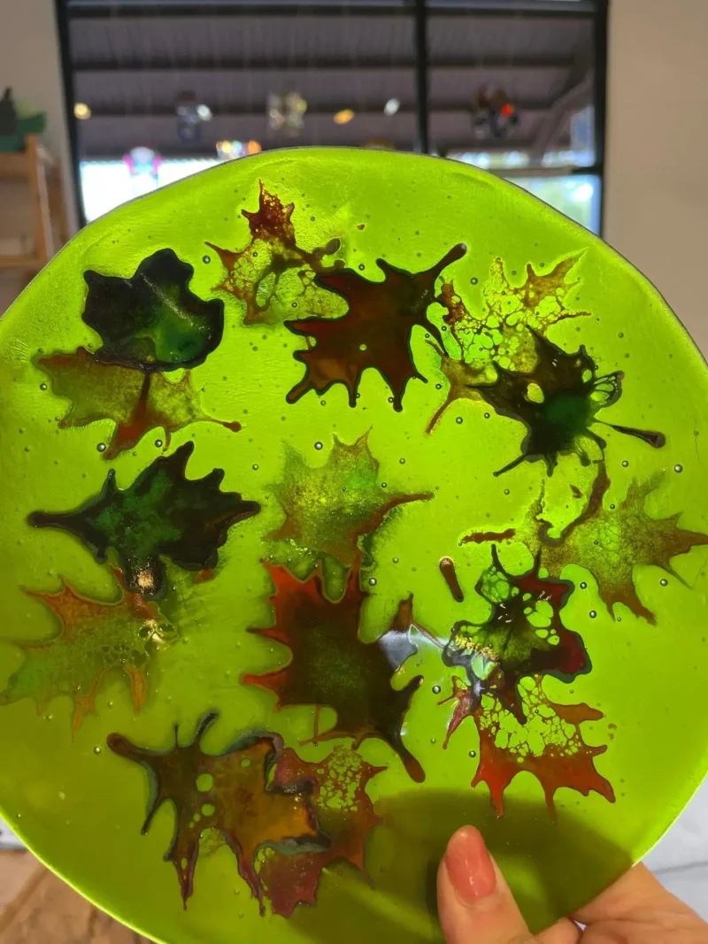Colorful Fall leaves on a green plate