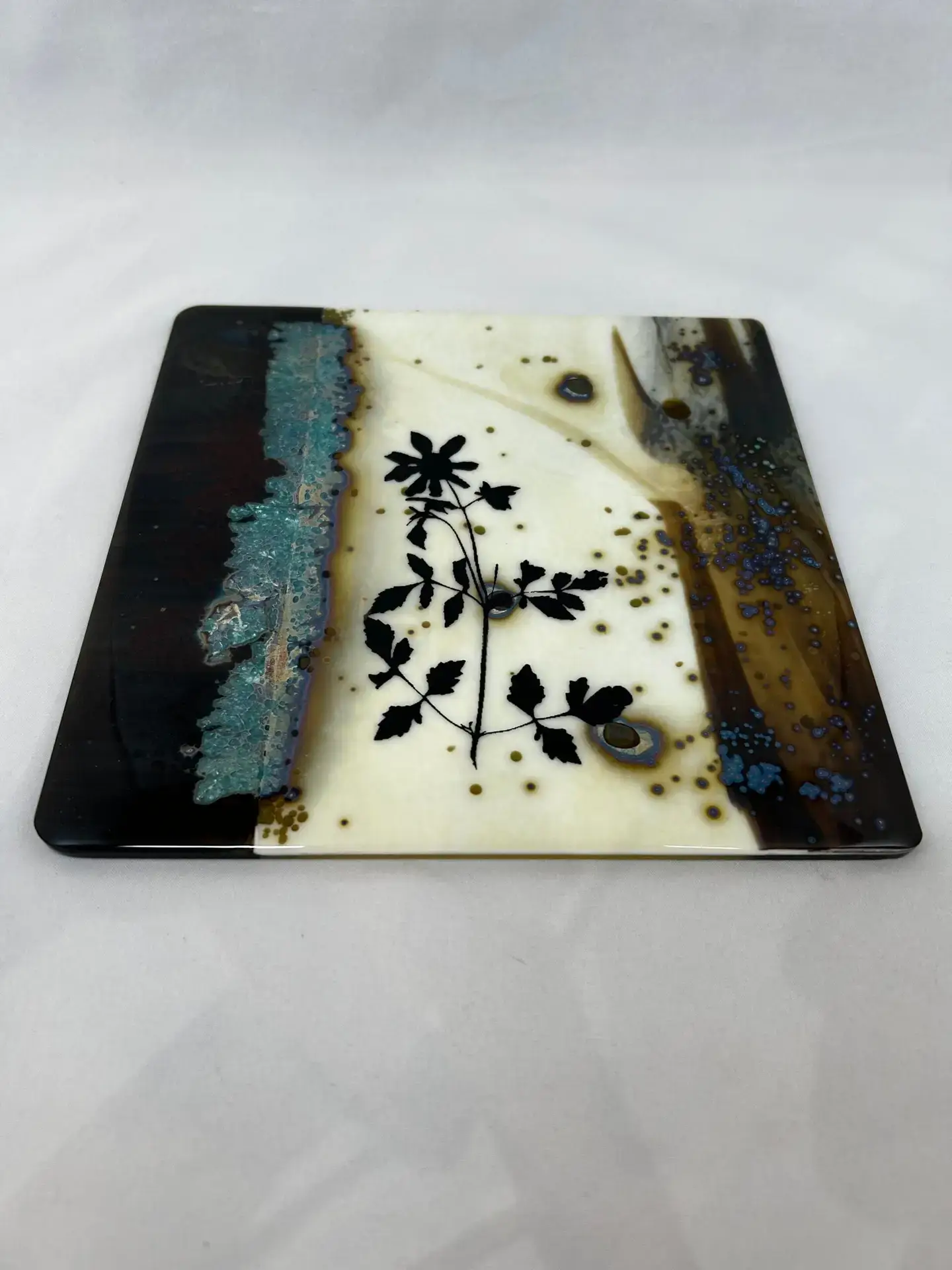 Detail view of floral silhouettes and earthy blue tones in Nature's Imprint