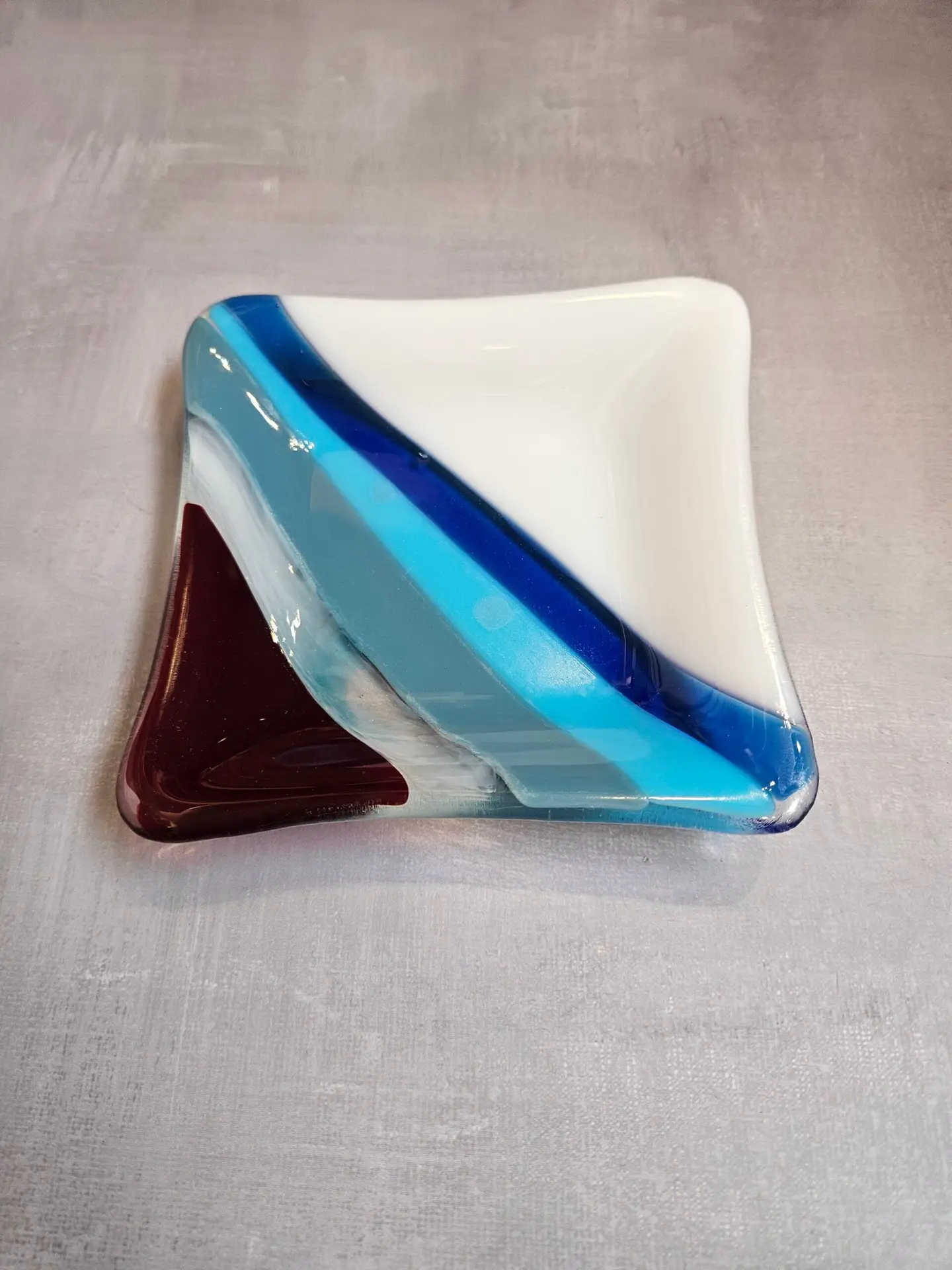 Diagonal strips dance across this dish with White and blues.