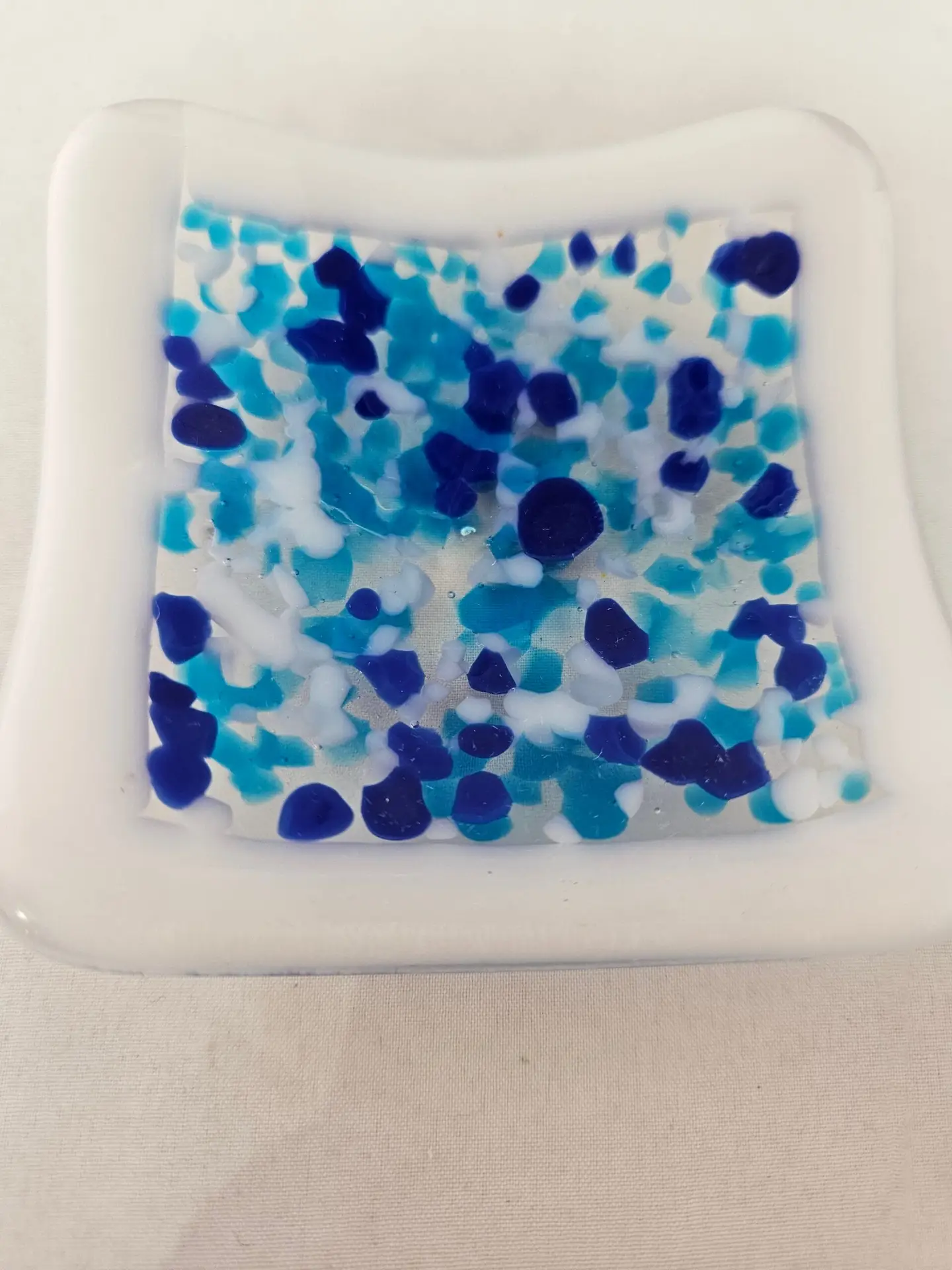 Blue crushed glass on white dish