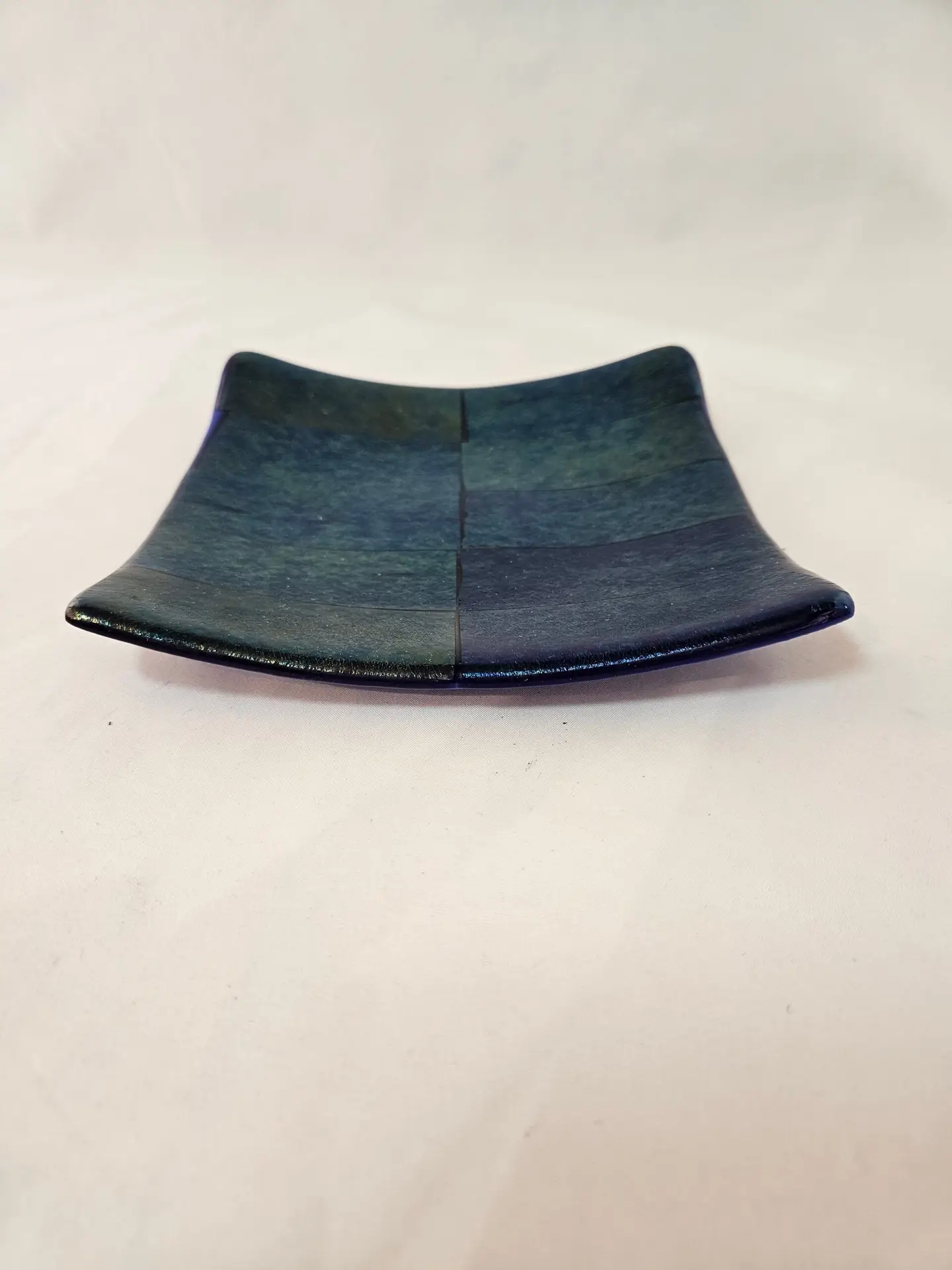 Detail view of blue green and golden metallic tones in Gilded Eclipse