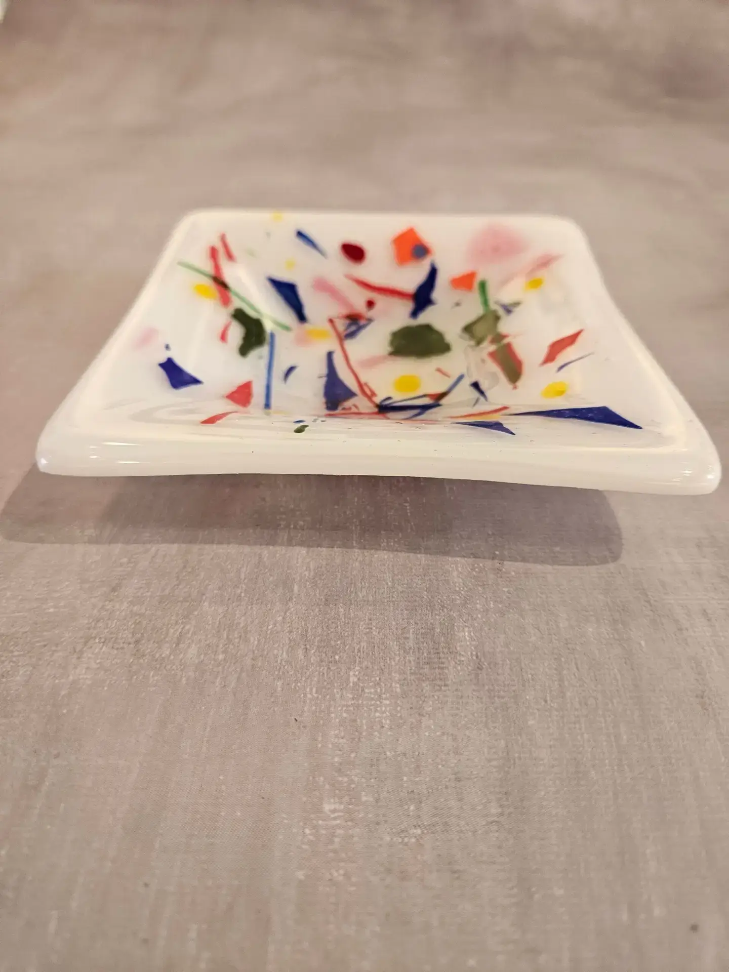 Detail view of red blue green and yellow glass accents in Confetti Fusion