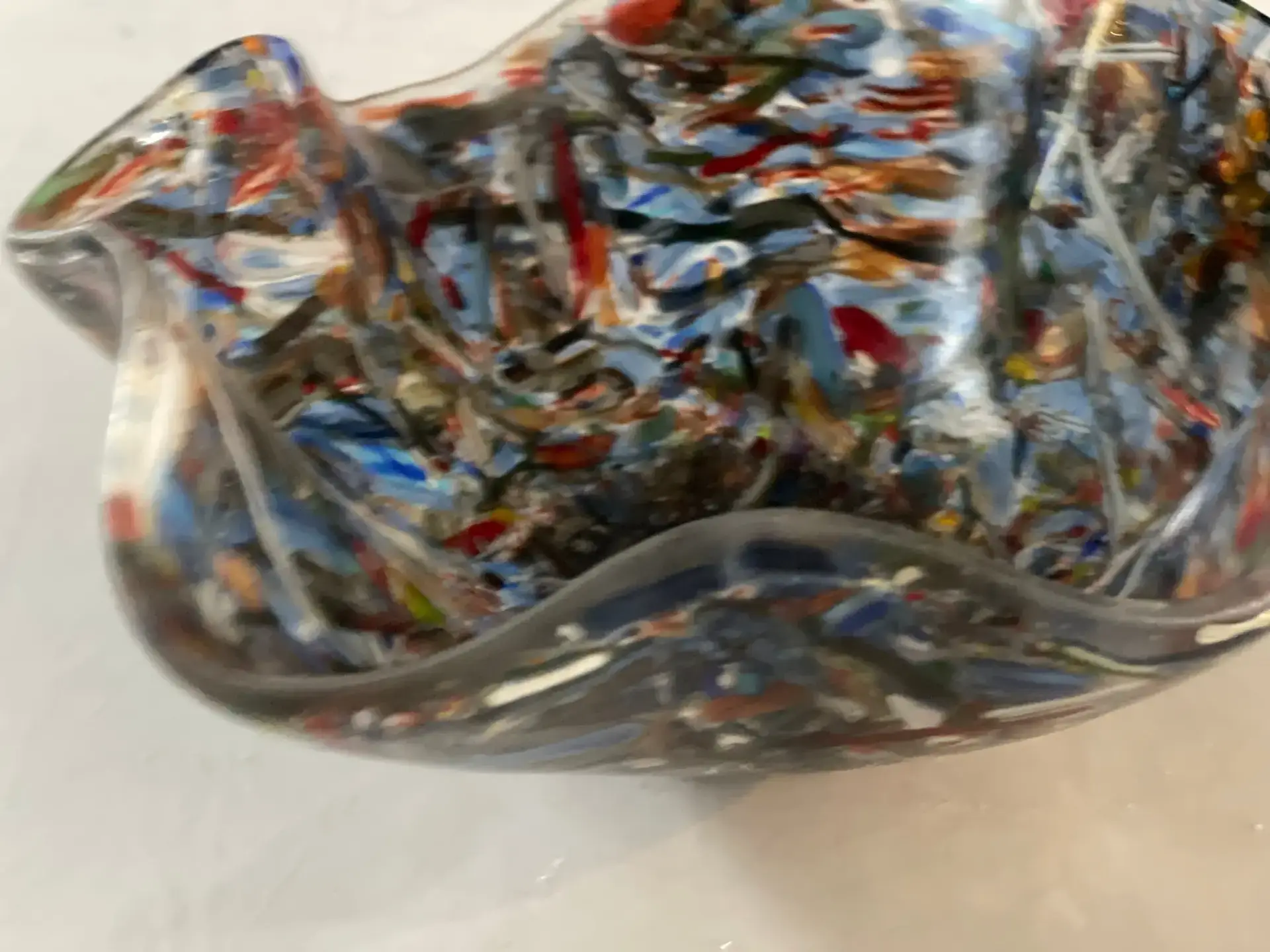 Detail view of swirling multicolor glass in fused glass bowl