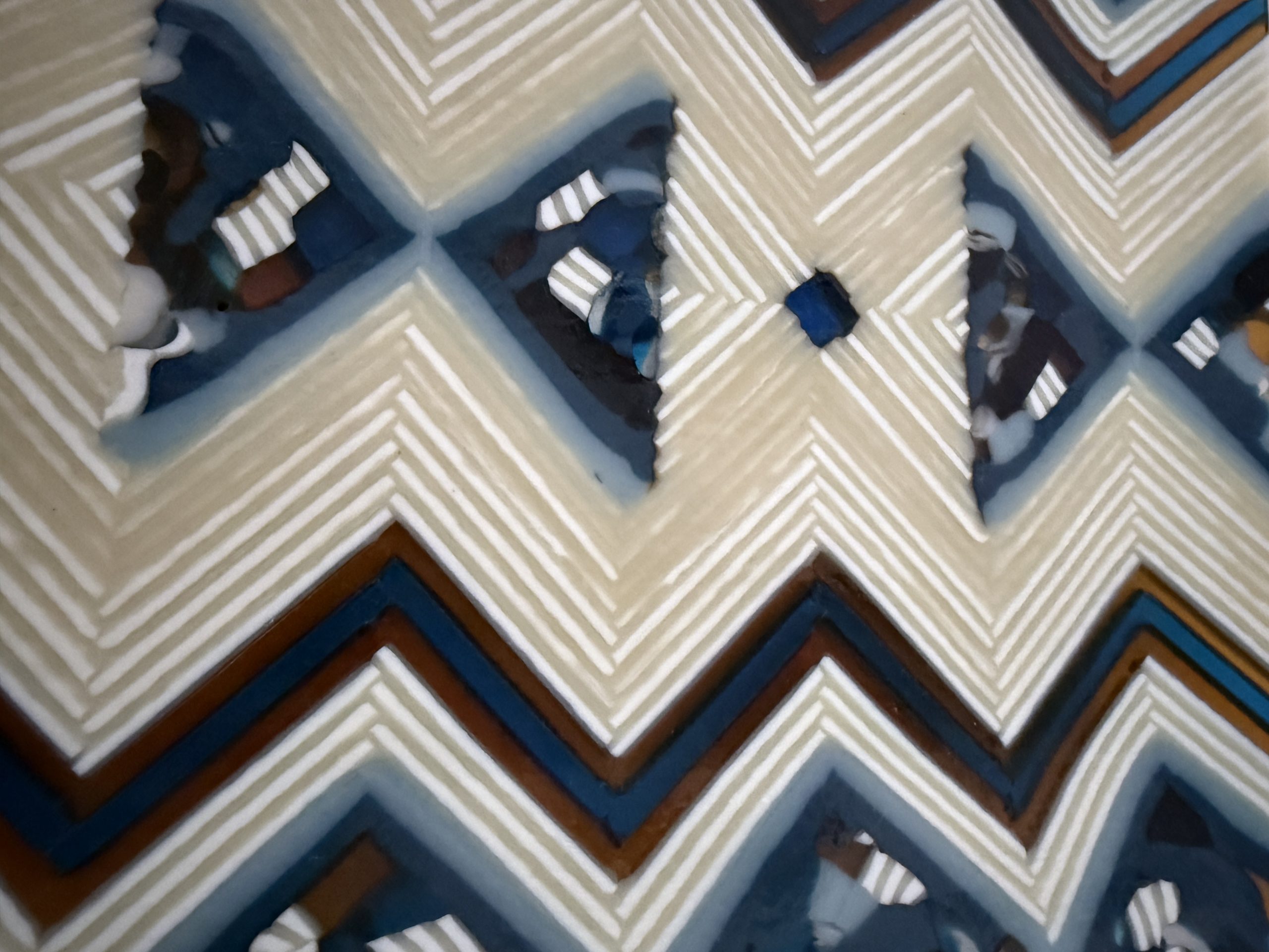 Fused glass art panel by Patty Heinen featuring intricate on-the-edge pattern bars with cream, blue, amber, and charcoal zig-zag designs.
