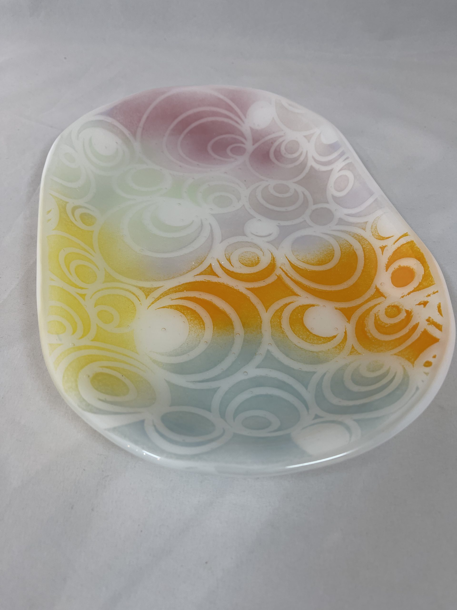 Fused glass platter with pastel colors and circle designs