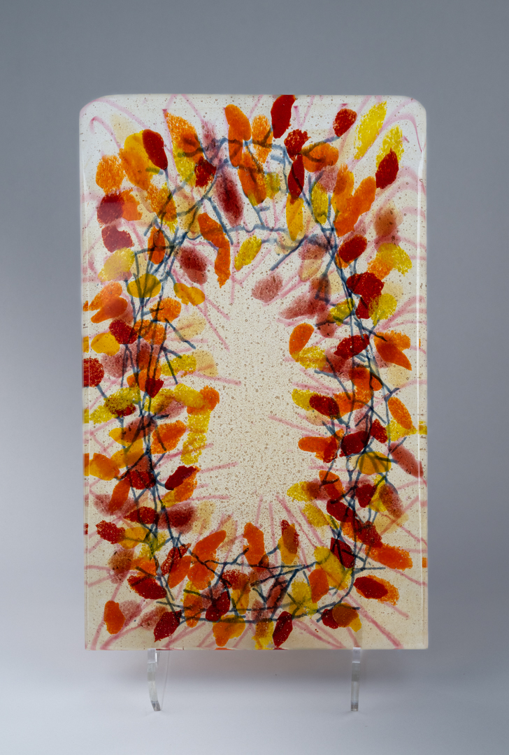 Autumn Revelry by Stella Schloss, a transparent cast glass tower with carved sculptural forms and autumn colors