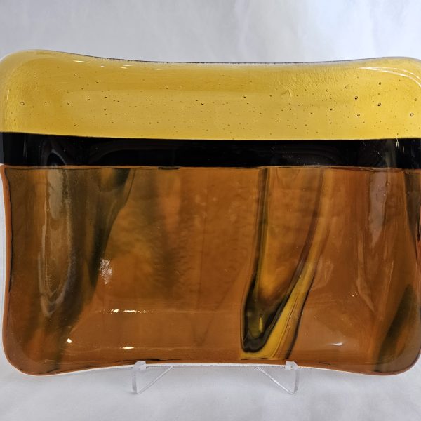 Contemporary amber fused glass plate by Nancy Dillingham Marks with flowing black accents