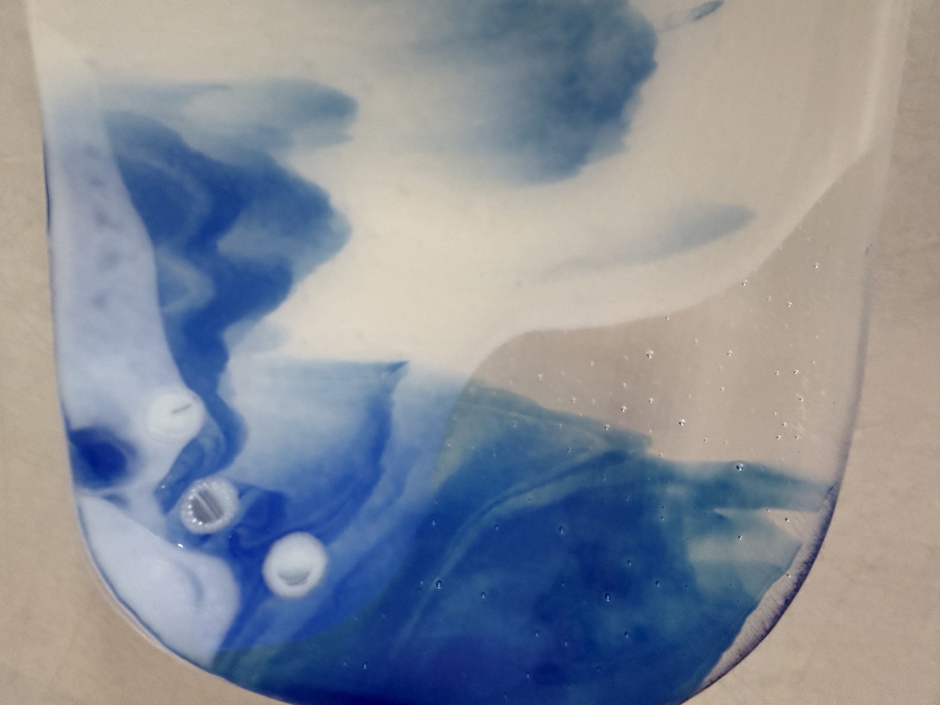 Close-up of blue and white fused glass detail on Blue Drift serving bowl