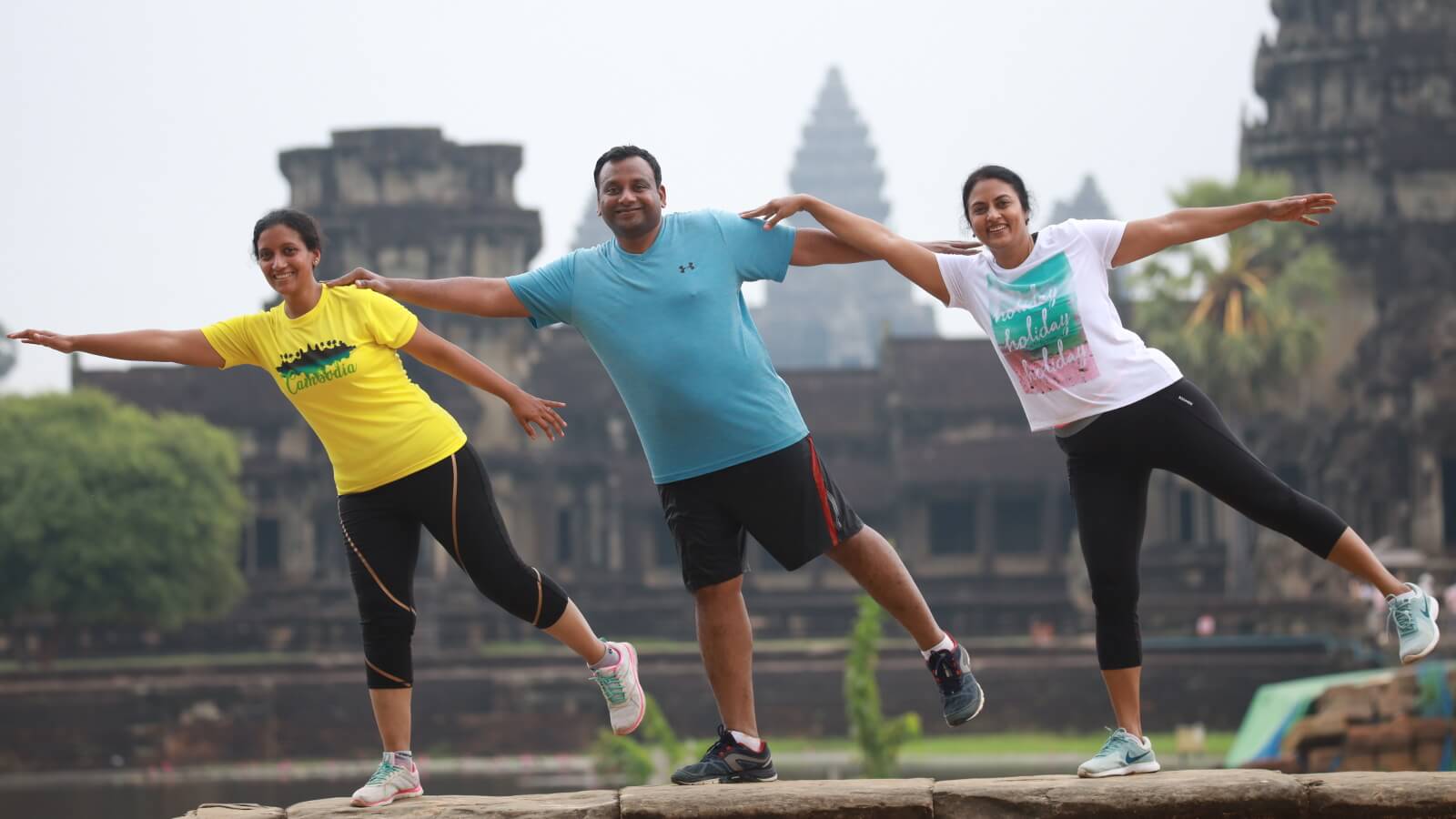 Angkor Wat at sunrise with runners