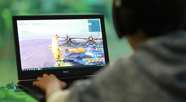 boy looking at fortnite on computer