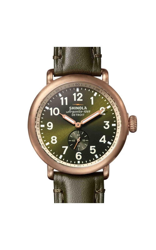 Shinola Bronze Runwell, 43mm Watch With Dark Olive Green Dial. The Dial Has A Seconds Sub-Dial, Bronze Lumen Hands, Arabic Markers. The Case is Satin Finish Bronze with a Dark Olive Green Leather Watch Strap and Bronze Buckle. S01 014 00059