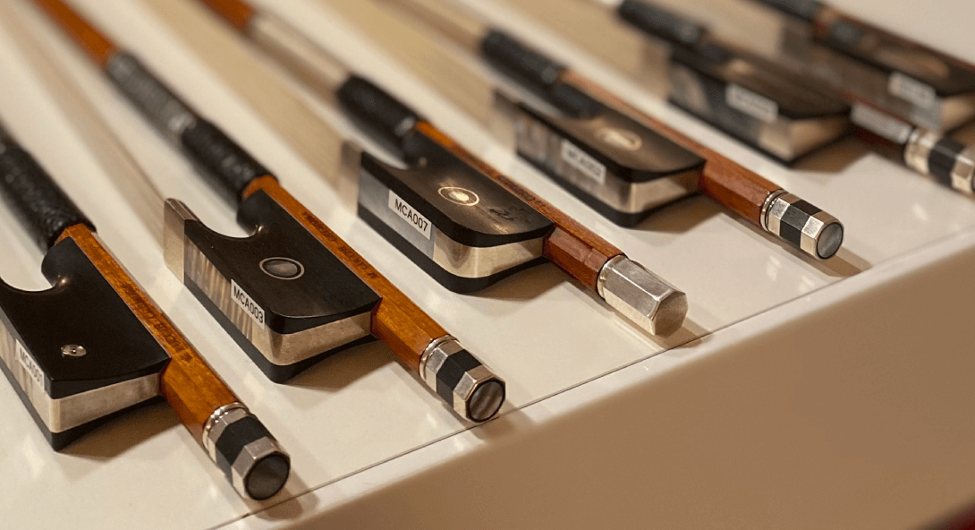 violin bow making - handcrafted violins bows side by side on a table Mio Cannone Violini