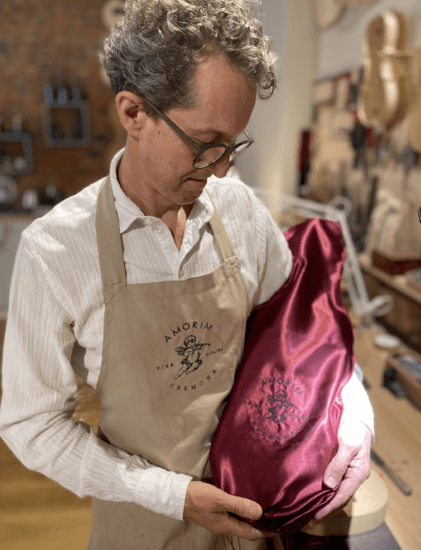 luthier holding a violin inside a bag