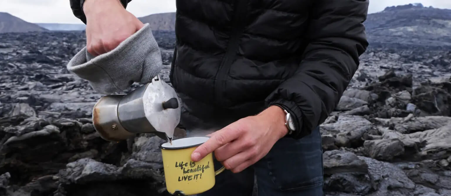 A man pours coffee into his cup.