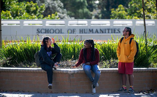 Students near the Humanities bridge