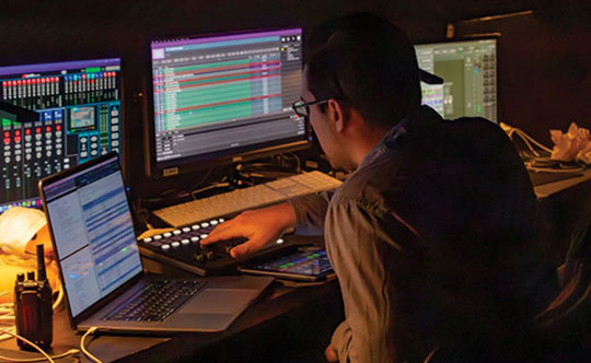 Student working on audio system at an arts internship 