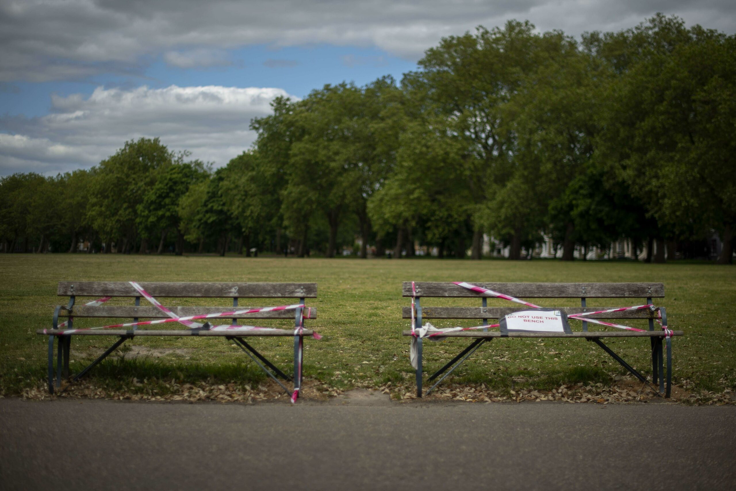 Park benches remain taped off in Victoria Park in East London.