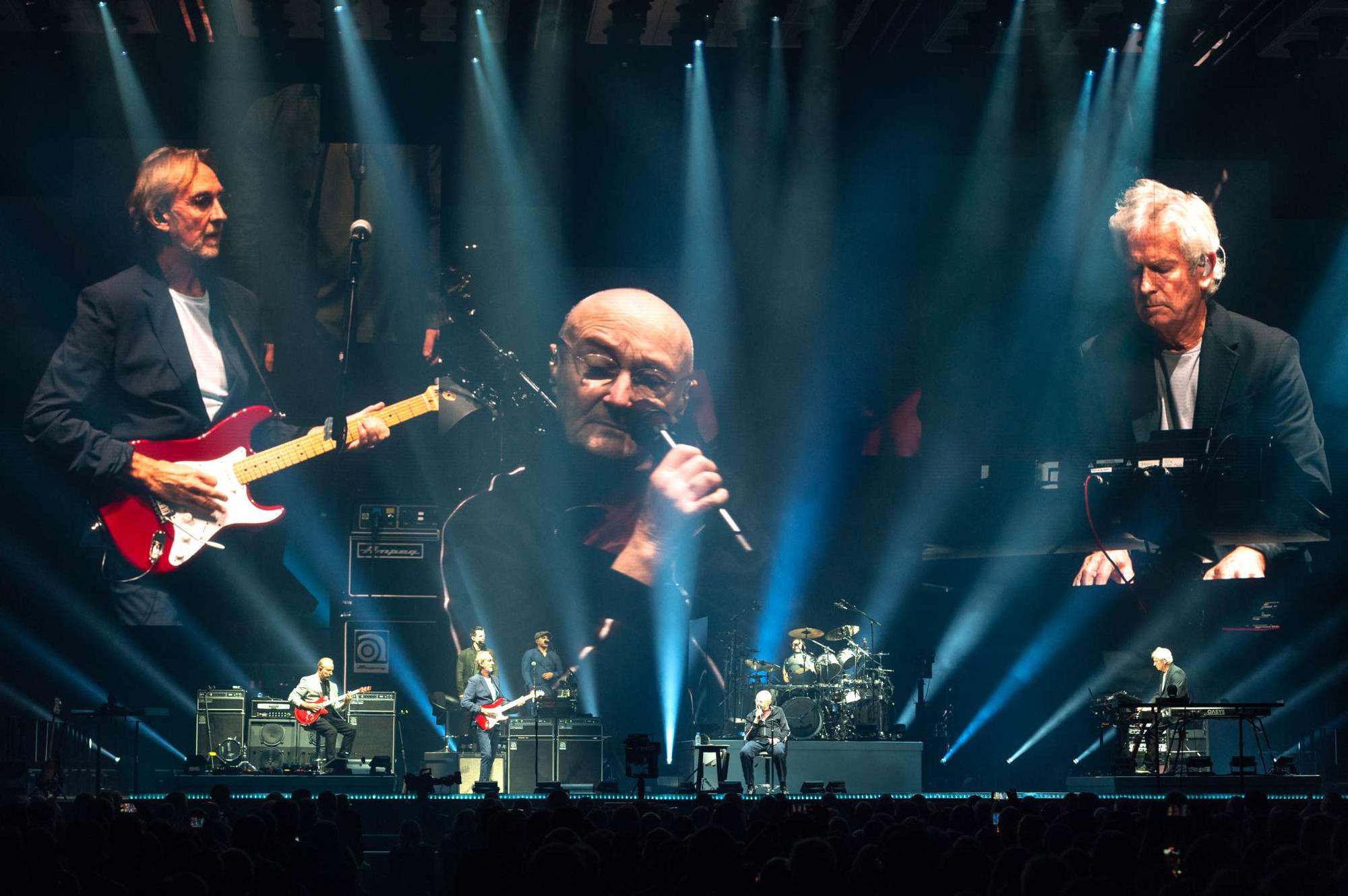 Mike Rutherford, Phil Collins and Tony Banks of Genesis perform on stage at the OVO Hydro in Glasgow, Scotland, Oct. 7.