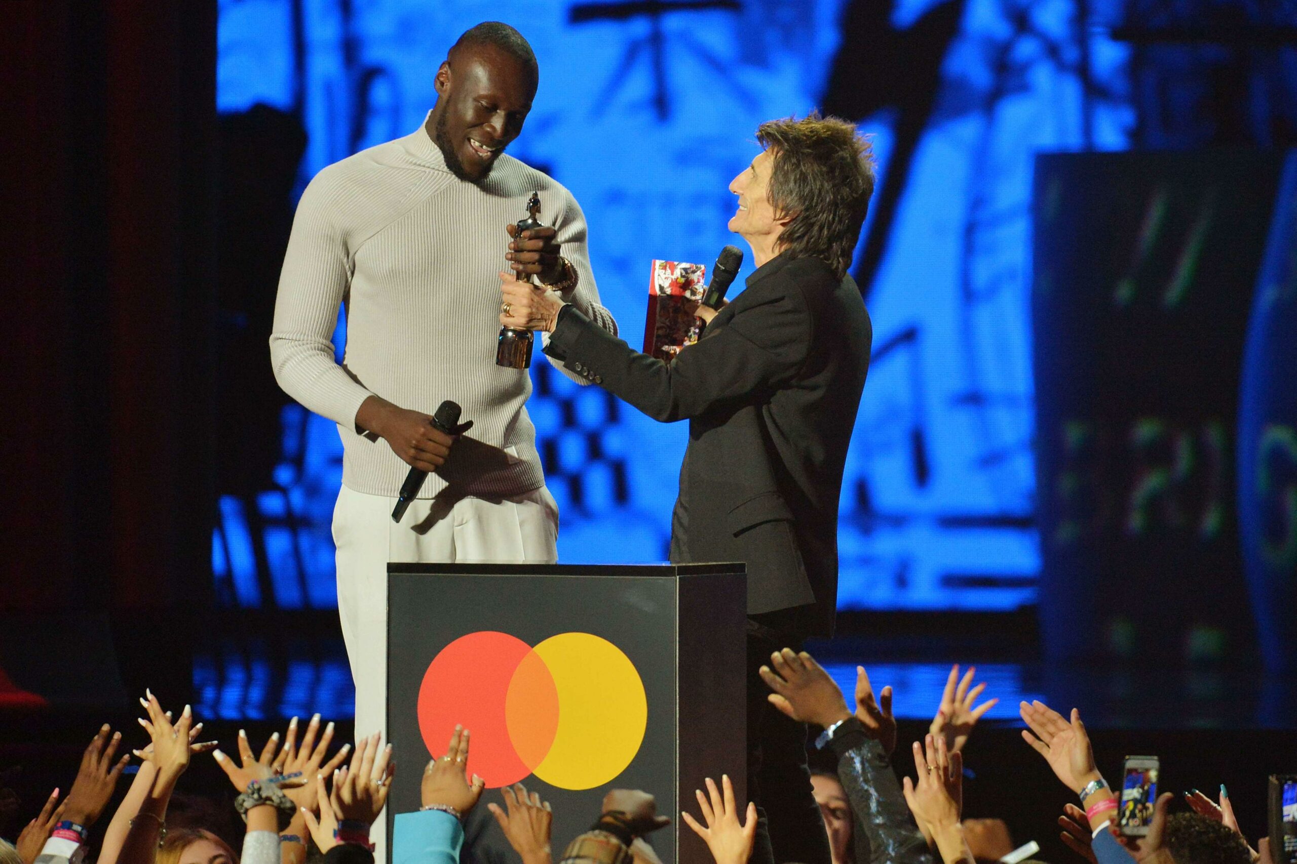 Stormzy accepts the Best Male Solo Artist award from Ronnie Wood during The BRIT Awards 2020 at The O2 Arena London, Feb. 18, 2020.