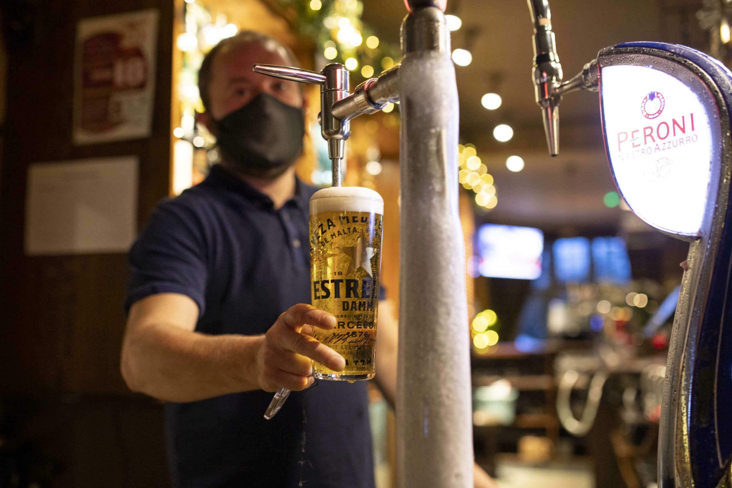 A barman serves a pint of lager at The Plymouth Arms pub in Cardiff, Wales.