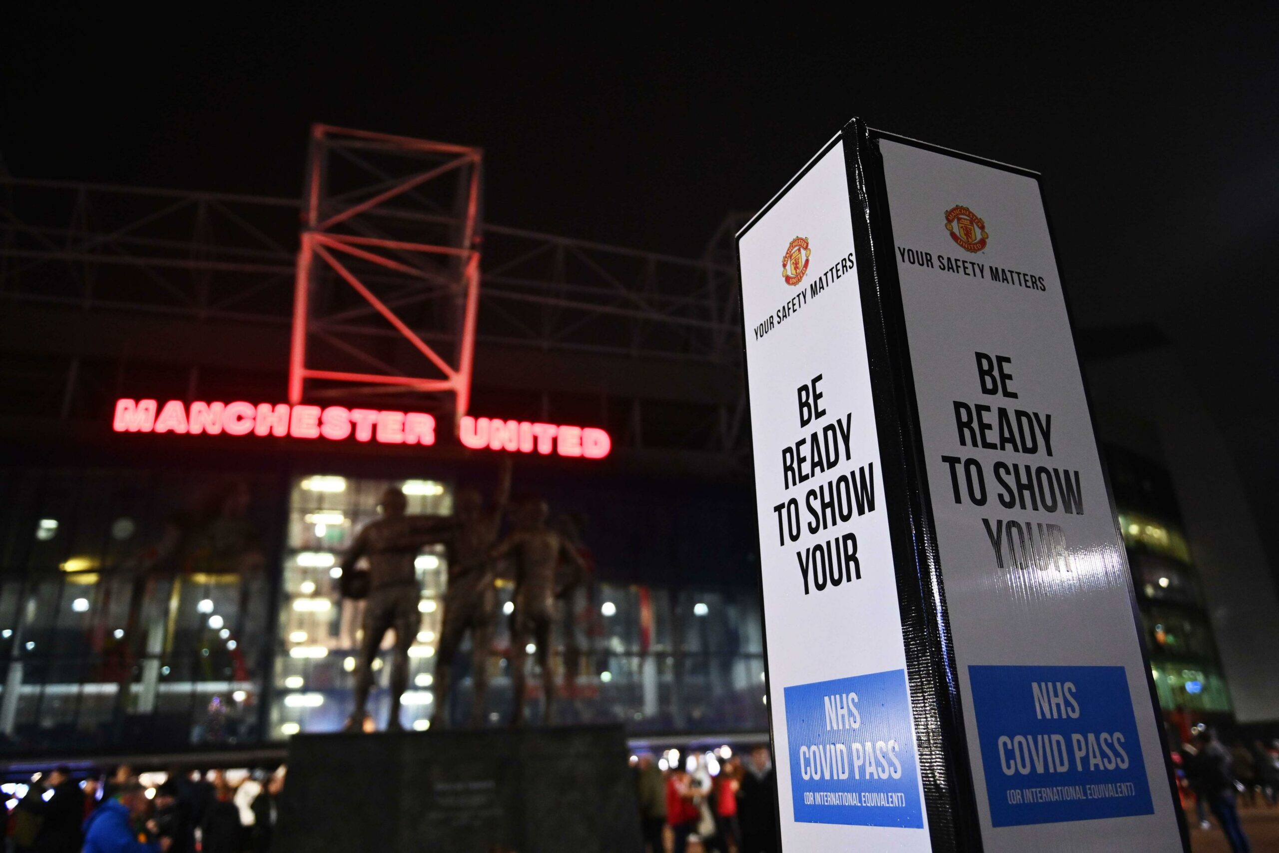 A NHS Covid Pass banner is seen outside the Old Trafford stadium in Manchester, England, Dec. 30, 2021. 